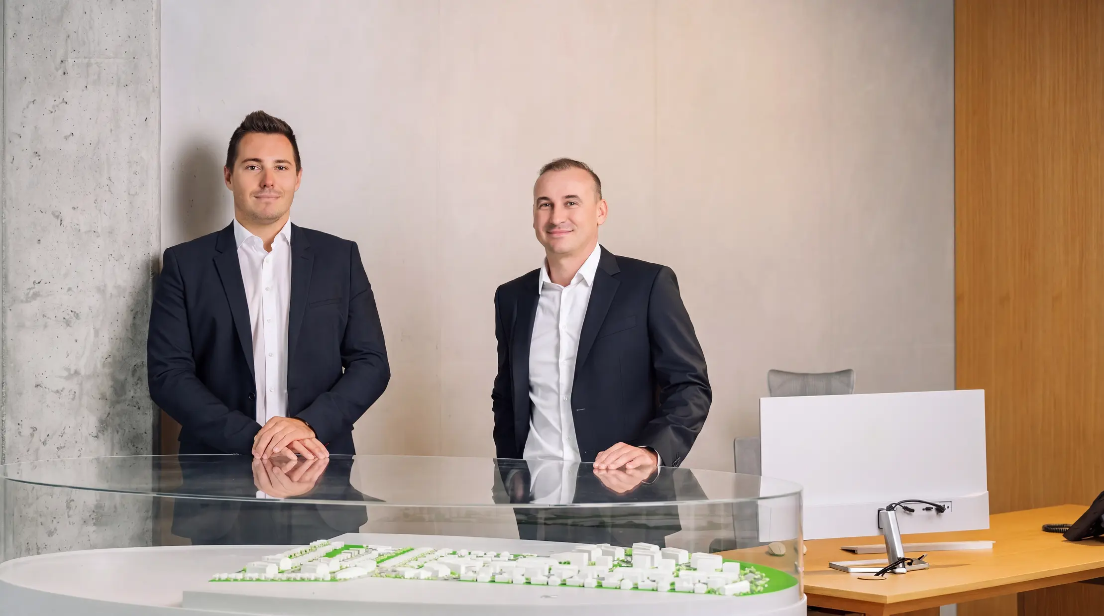 Developers standing behind a city model